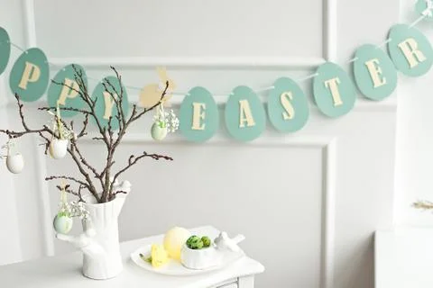 Composition with Easter eggs in glass jar and wicker basket, and blooming Stock Photos