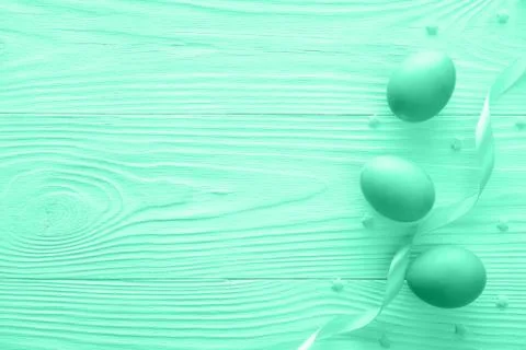 Composition of Easter eggs with ribbon on wooden background. Top view with copy Stock Photos