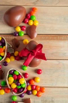 Composition of Easter sweets - chocolate eggs and candies on a brown backgrou Stock Photos