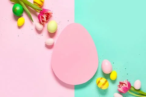 Composition with egg-shaped blank card, sprinkles, flowers and Easter eggs on Stock Photos