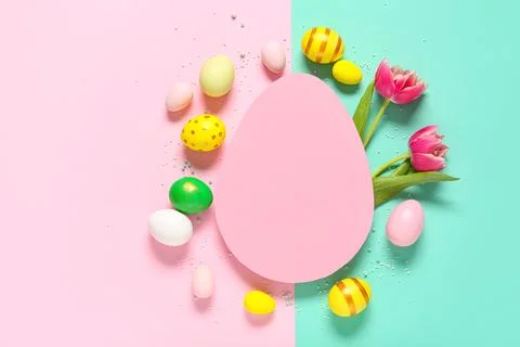 Composition with egg-shaped blank card, sprinkles, flowers and Easter eggs on Stock Photos