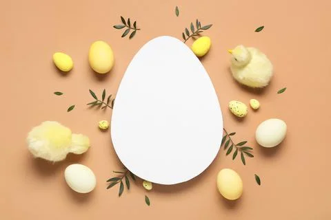 Composition with egg-shaped blank card, Easter eggs, baby chickens and green  Stock Photos