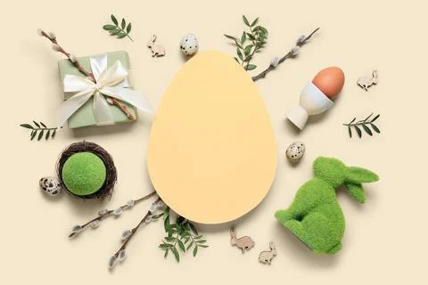 Composition with egg-shaped blank card, Easter eggs, gift box and pussy willo Stock Photos