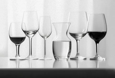 Composition of empty different types of wine glasses in shape and size on a.. Stock Photos
