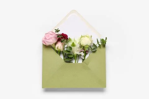 Composition with envelope and beautiful flowers on white background Stock Photos