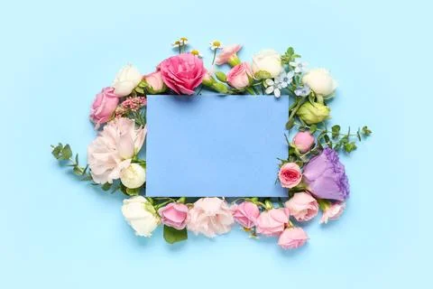 Composition with envelope and different flowers on blue background Stock Photos