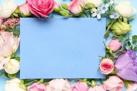 Composition with envelope and different flowers on blue background, closeup Stock Photos