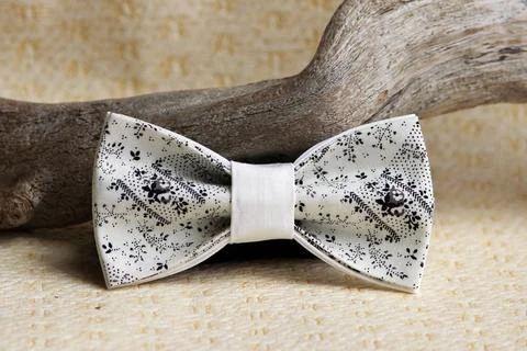 Composition: Extravagant beige with a black small pattern of a bow tie and... Foto stock