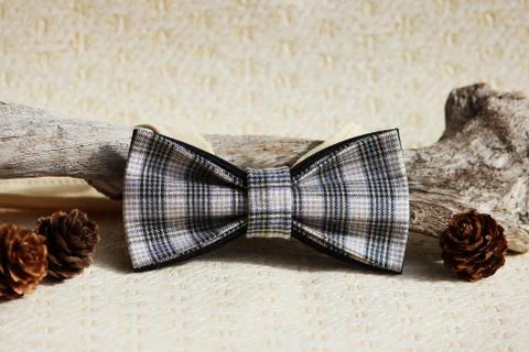 Composition: Extravagant checkered beige with a black small pattern of a bow tie Stock Photos