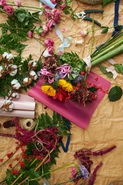 Composition flat-lay of flowers and florists instruments on parchment paper Stock Photos