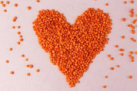 Composition flat lay of Raw lentils in the shape of heart Stock Photos