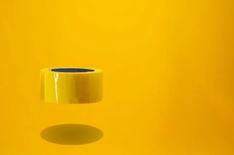 Composition of floating yellow tape. Copy space. Monochromatic composition Stock Photos