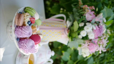 Composition with flowers, macaroons sweets desert and coffee and tea Stock Footage 252079551