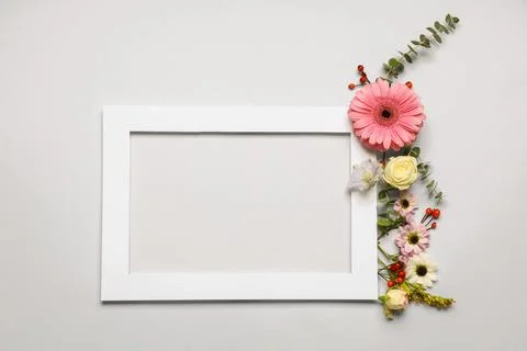 Composition with frame and beautiful flowers on white background Foto stock
