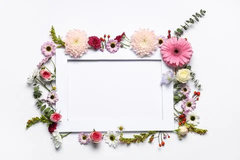 Composition with frame and different beautiful flowers on white background Foto stock