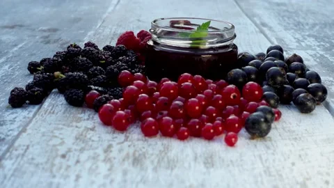 Composition of fresh berries and jam jars. Stock Footage 157561675