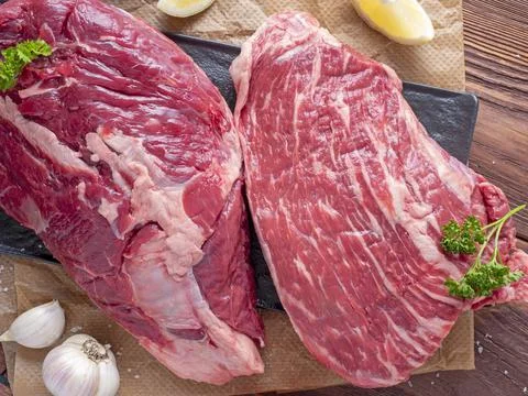 Composition of fresh pieces of beef, vegetables, spices, Wooden background, p Stock Photos