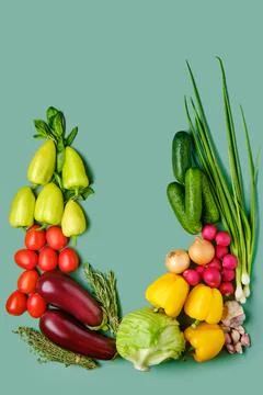Composition with fresh vegetables on pale green background Stock Photos