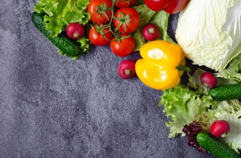 Composition of fresh vegetables with place for text on a dark gray background Stock Photos