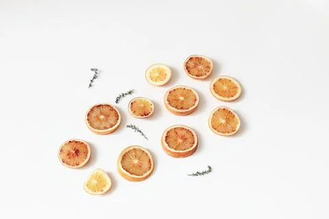 Composition of fresh whole and slice cut bloody oranges with thyme herb isolated 스톡 사진