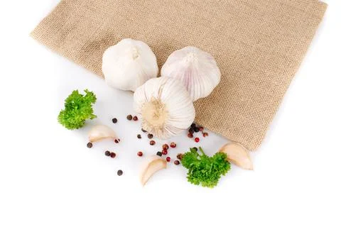 Composition of garlic and pasley on sacking, close up Stock Photos