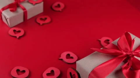 Composition with a gift box tied with a red ribbon with a bow, hearts close-up Stock Footage 167330340