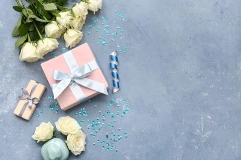 Composition with gift box, white rose flowers and bottle of perfume on blue g Stock Photos