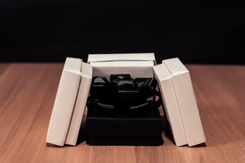 Composition of gift boxes. In the center is a box with a bow of dark color Foto stock