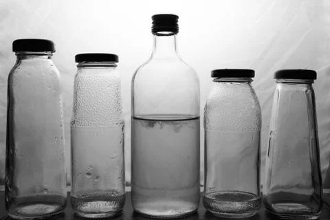 Composition of glass bottles on a light background Stock Photos