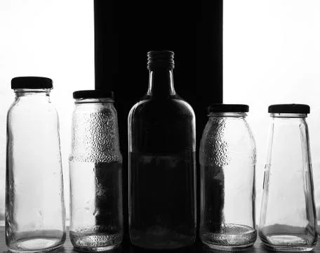 Composition of glass bottles on a light background Stock Photos