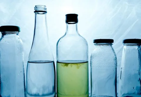Composition of glass bottles on a light background Stock Photos