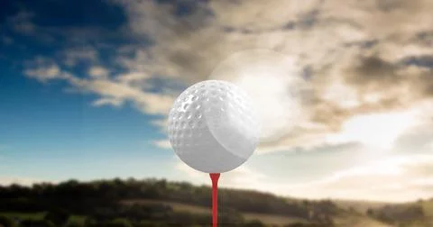 Composition of golf ball on red tee over landscape Fotos Stock