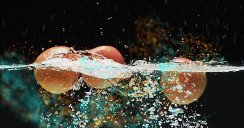 Composition of green leaves over oranges floating in water on black background Stock Footage 263916443