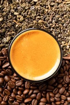 Composition of green tea, coffee beans and coffee in a cup on a dark backgr.. Stock Photos