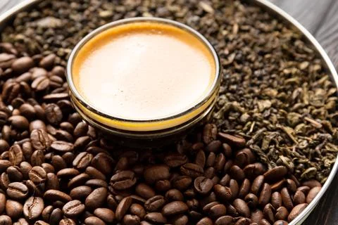 Composition of green tea, coffee beans and coffee in a cup on a dark backgr.. Stock Photos