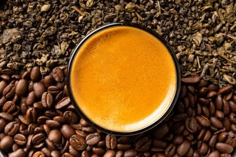 Composition of green tea, coffee beans and coffee in a cup on a dark backgr.. Stock Photos