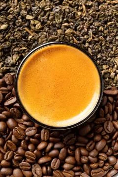 Composition of green tea, coffee beans and coffee in a cup on a dark backgr.. Stock Photos