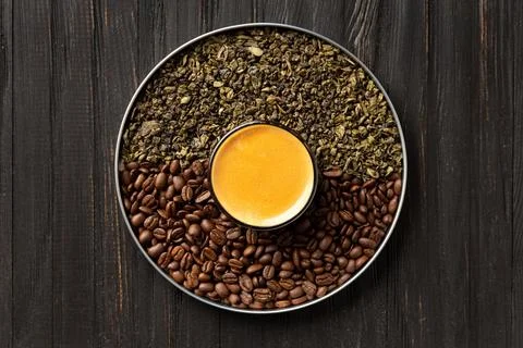 Composition of green tea, coffee beans and coffee in a cup on a dark backgr.. Stock Photos