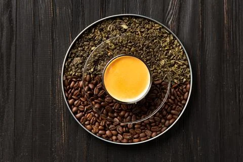 Composition of green tea, coffee beans and coffee in a cup on a dark backgr.. Stock Photos