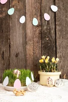 Composition for greeting card: Easter eggs, yellow crocus, grass, rabbits Stock Photos