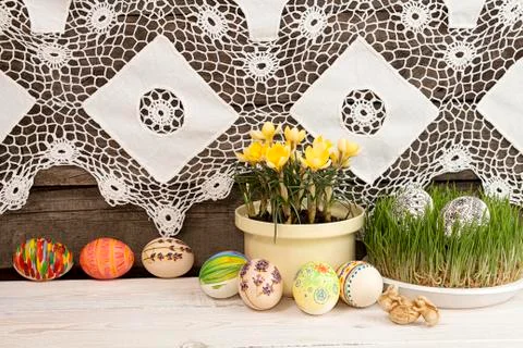 Composition for greeting card: Easter eggs, yellow crocus, grass, rabbits, gr Stock Photos
