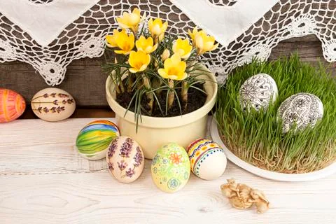 Composition for greeting card: Easter eggs, yellow crocus, grass, rabbits, gr Stock Photos