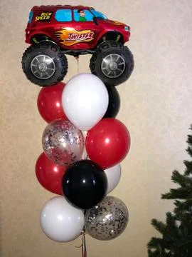 Composition of helium balloons of red, white, black and large truck figures Stock Photos