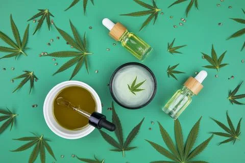 Composition with hemp oil cbd and bottle of oil on green background Stock Photos
