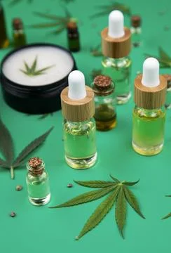 Composition with hemp oil cbd and bottle of oil on green background Stock Photos