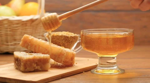 Composition of honey, honeycomb and bee bread. Honey pouring on honeycomb (No 4) Stock Footage 67134048
