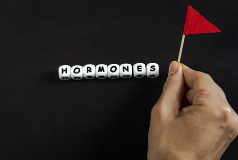 A composition with hormones text and red flag Stock Photos