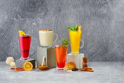Composition with hot fruit and herbal winter drinks on shabby grey background Foto stock