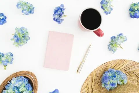 Composition of hydrangea flowers with straw, diary and mug of coffee on white Stock Photos