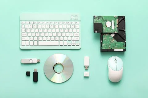 Composition with keyboard, mouse and different memory storage devices on turq Stock Photos